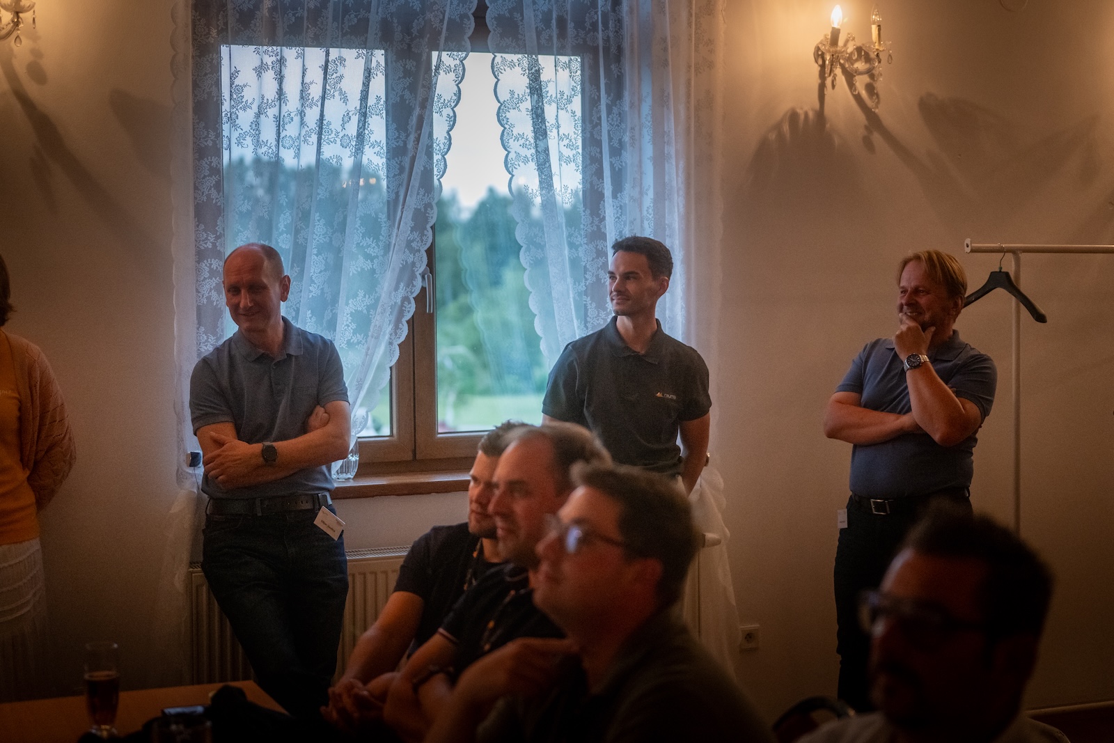 Raymo team members listening at the back of the conference room