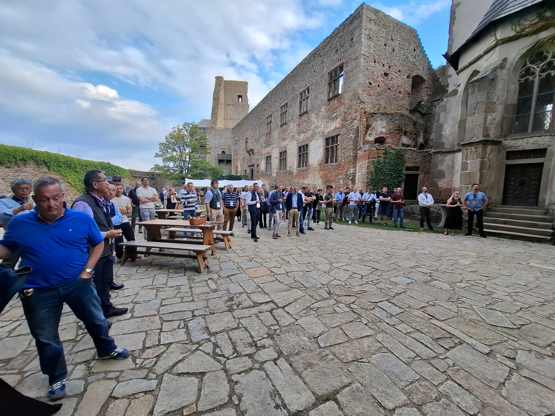 Guests gathered in the castle courtyard by the ruins