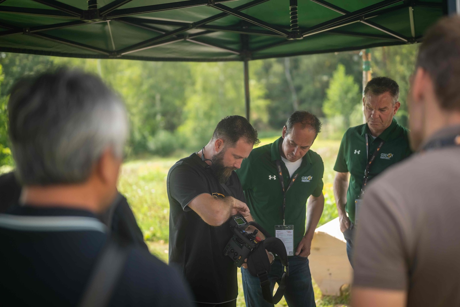 Raymo specialist showing the remote control unit to distributors under the tent