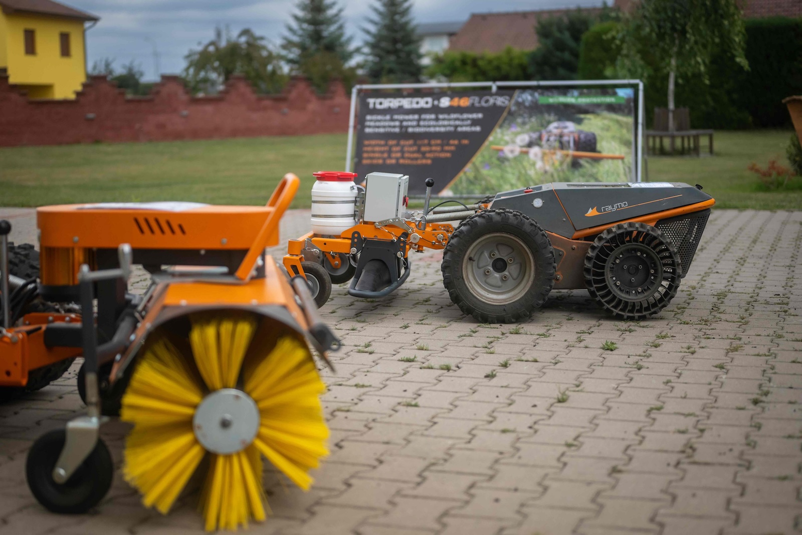Raymo machines with sweeper and spraying attachments lined up by the Torpedo S46 Floris banner
