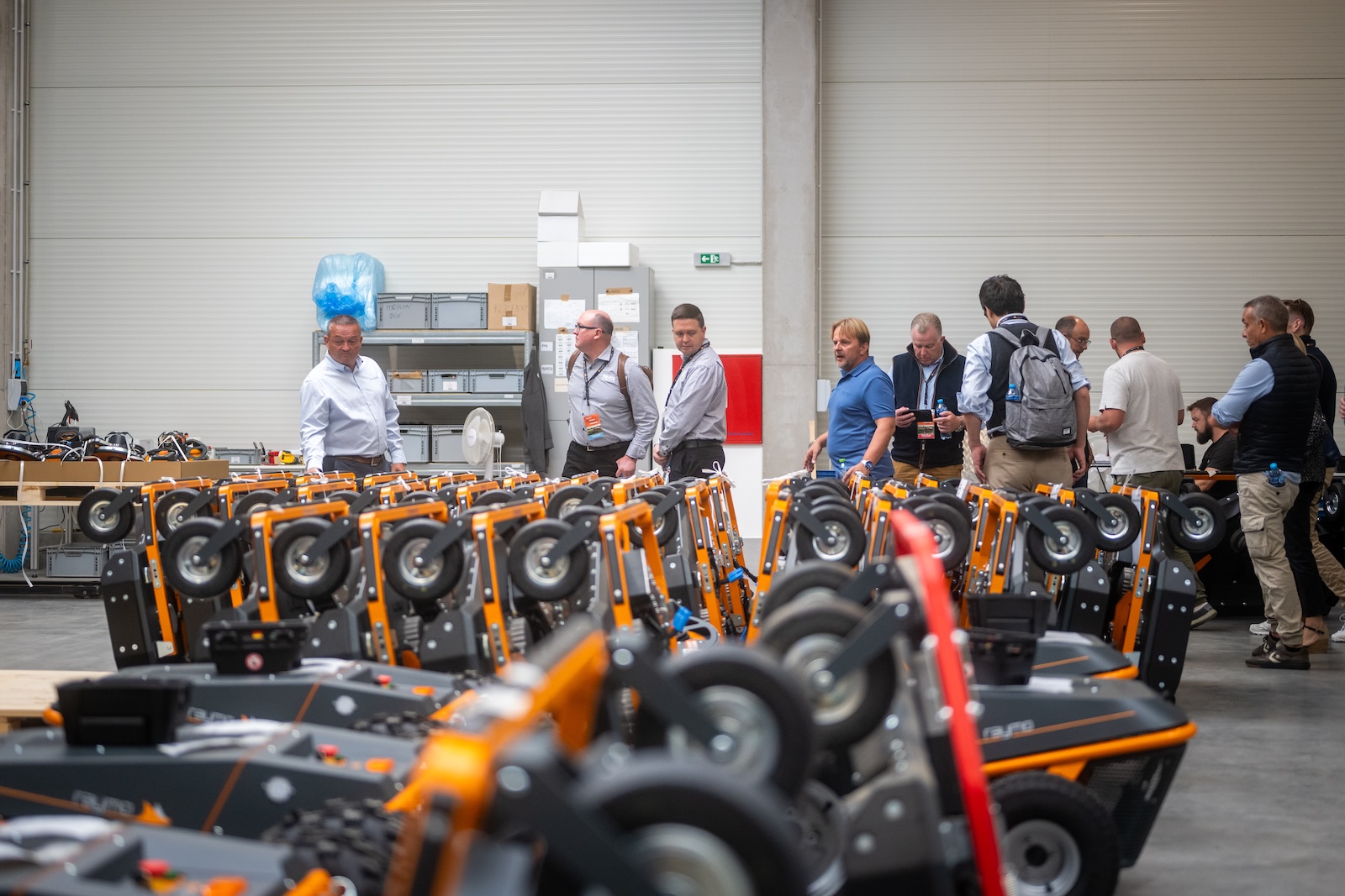 Rows of new Raymo mowing decks ready for shipment in the hall