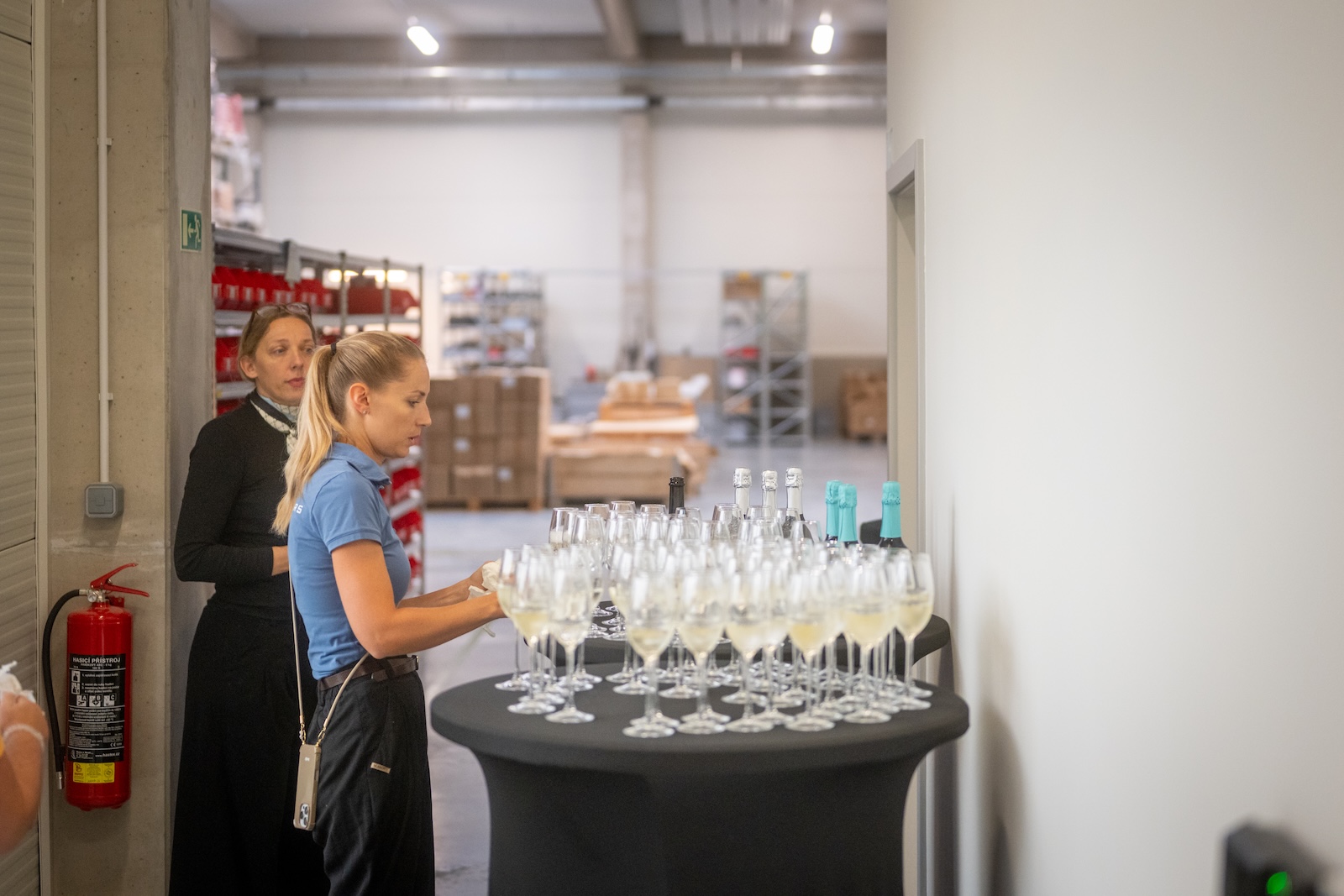 Hostess preparing welcome sparkling wine glasses