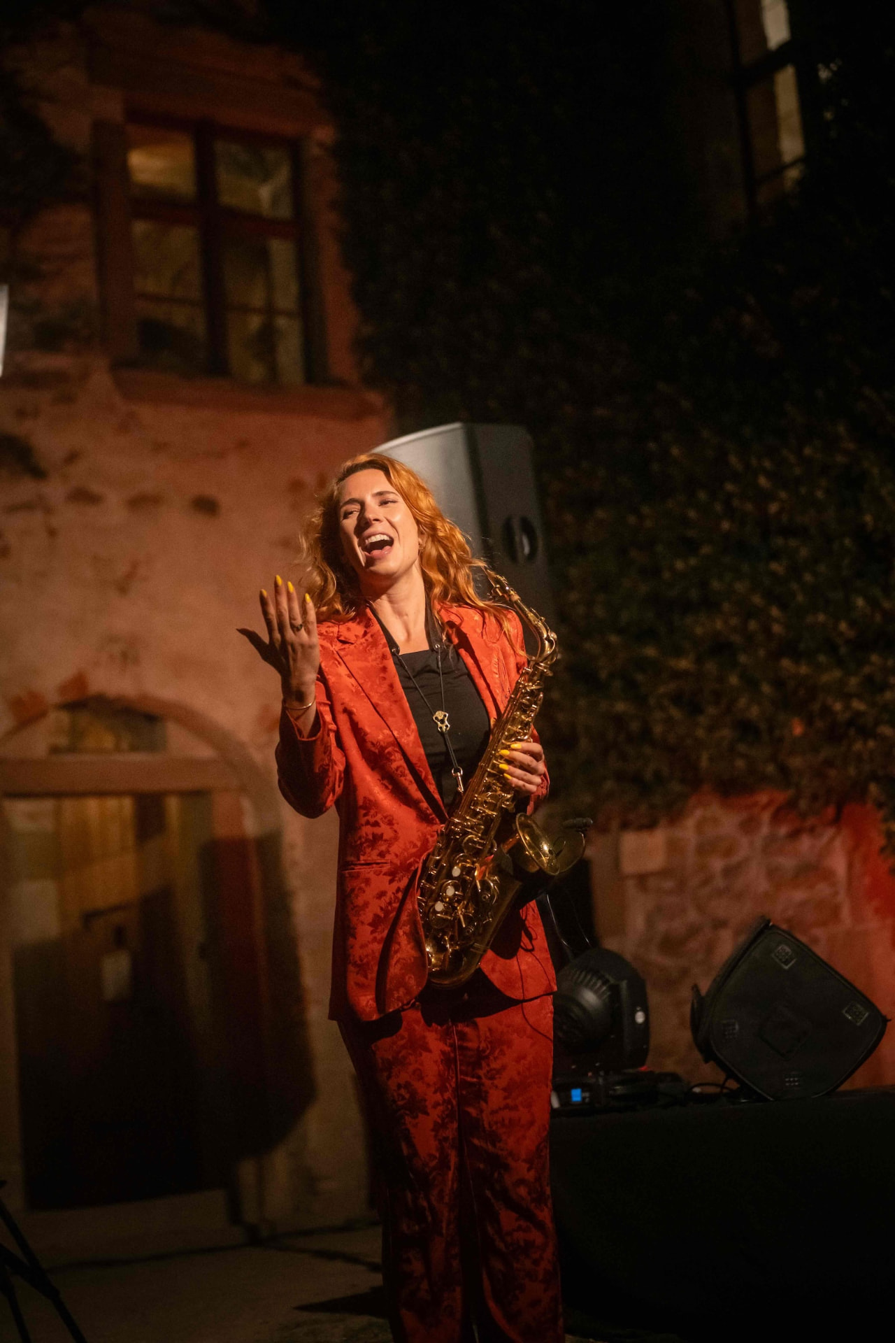 Saxophonist laughing while talking to the audience