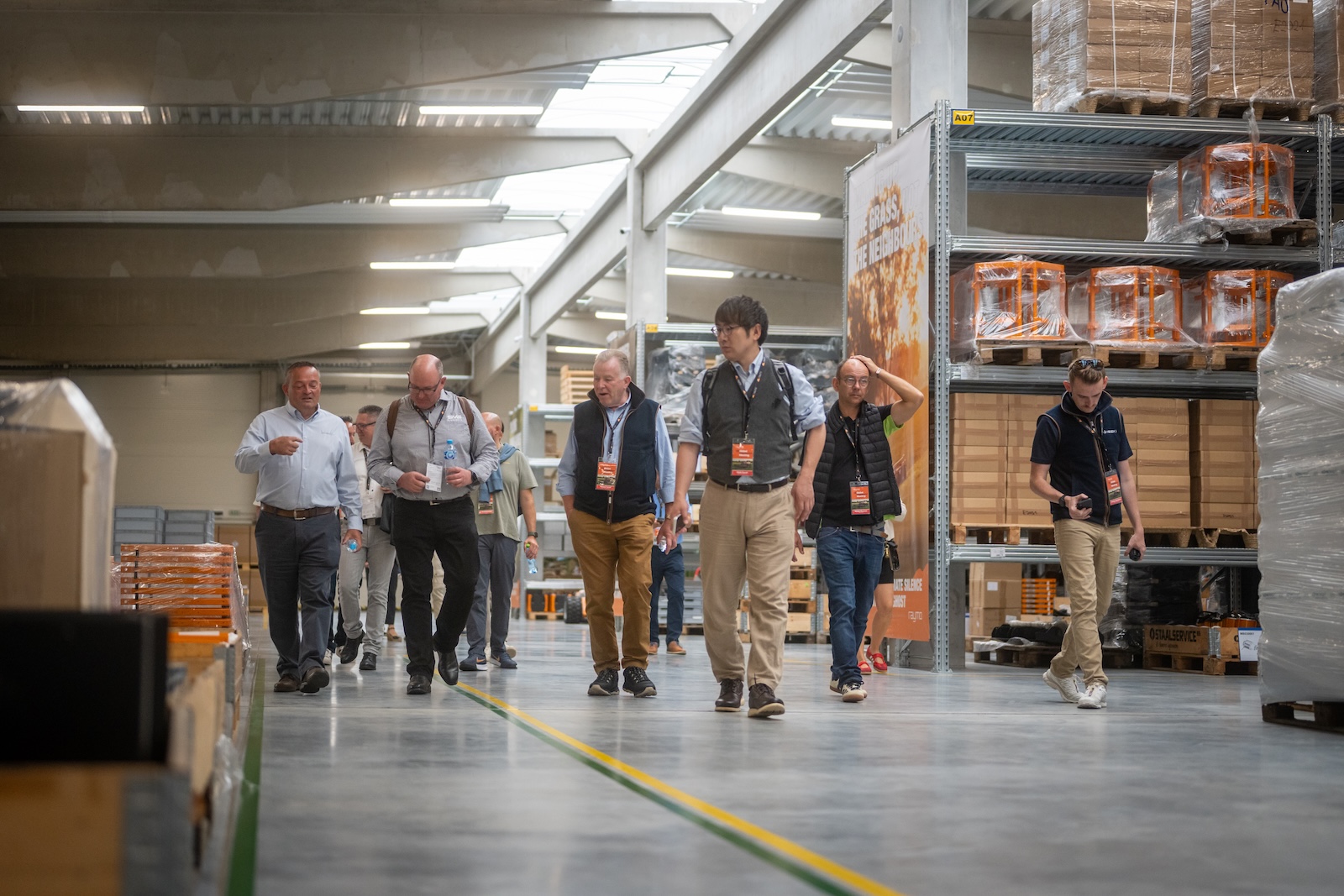 Distributors walking through the parts warehouse during the guided tour