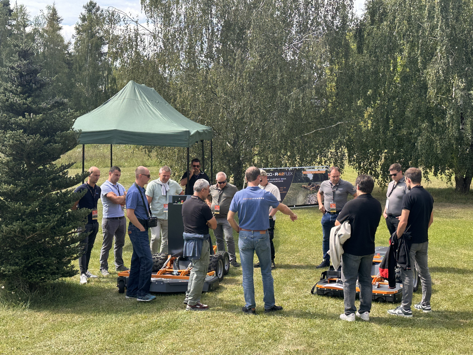 Group listening to a presenter at the R42FLEX demo tent