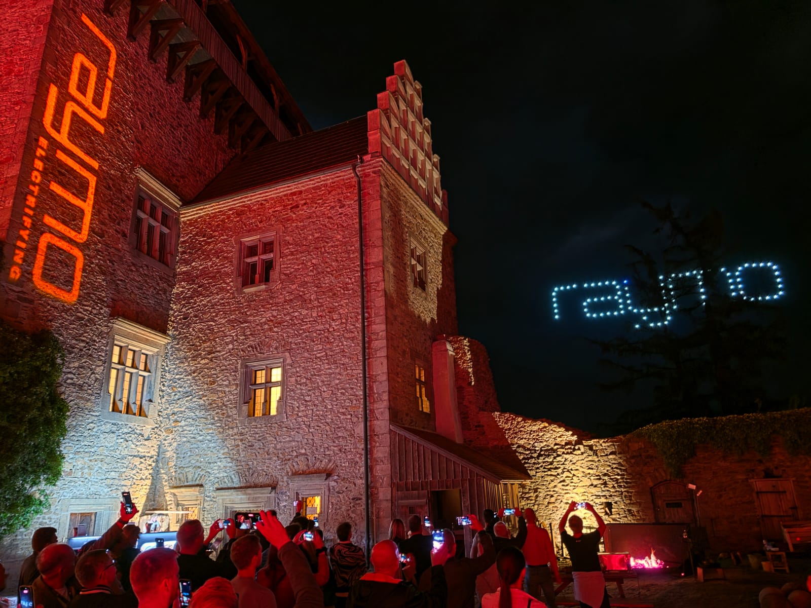 Guests filming the Raymo drone show in the night sky