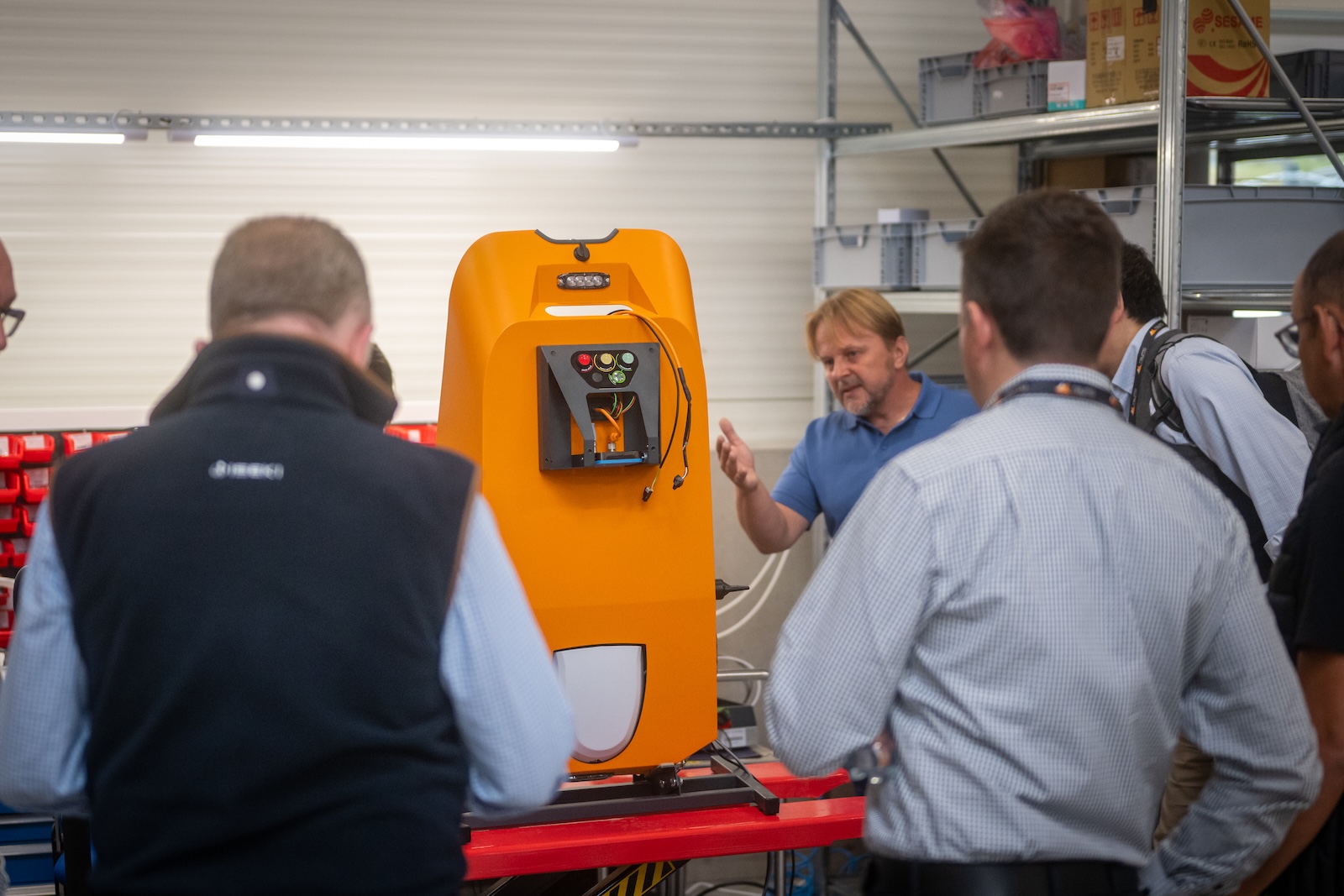 Raymo specialist explaining the machine chassis and controls to visitors