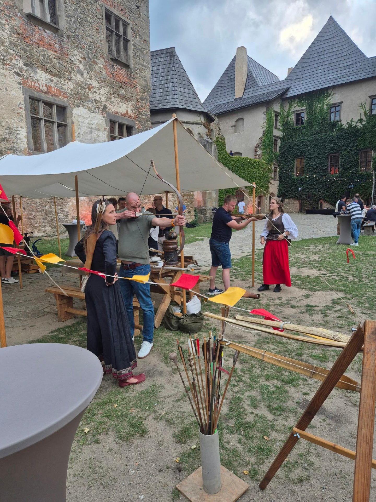 Archery activity with historical costumes in the castle courtyard
