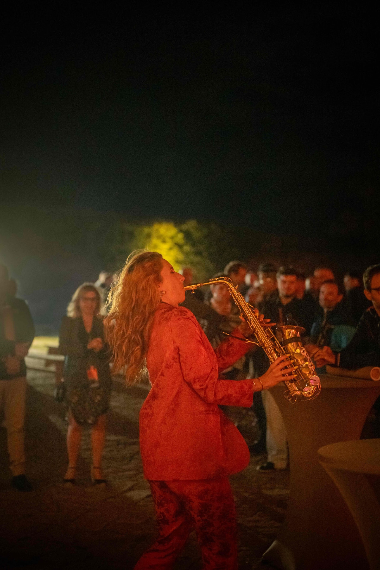 Saxophone performance in front of the audience at night