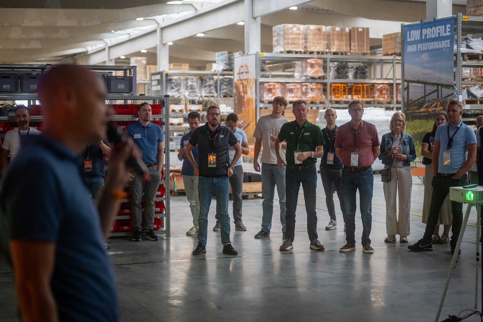 Speaker with a microphone addressing distributors in the warehouse