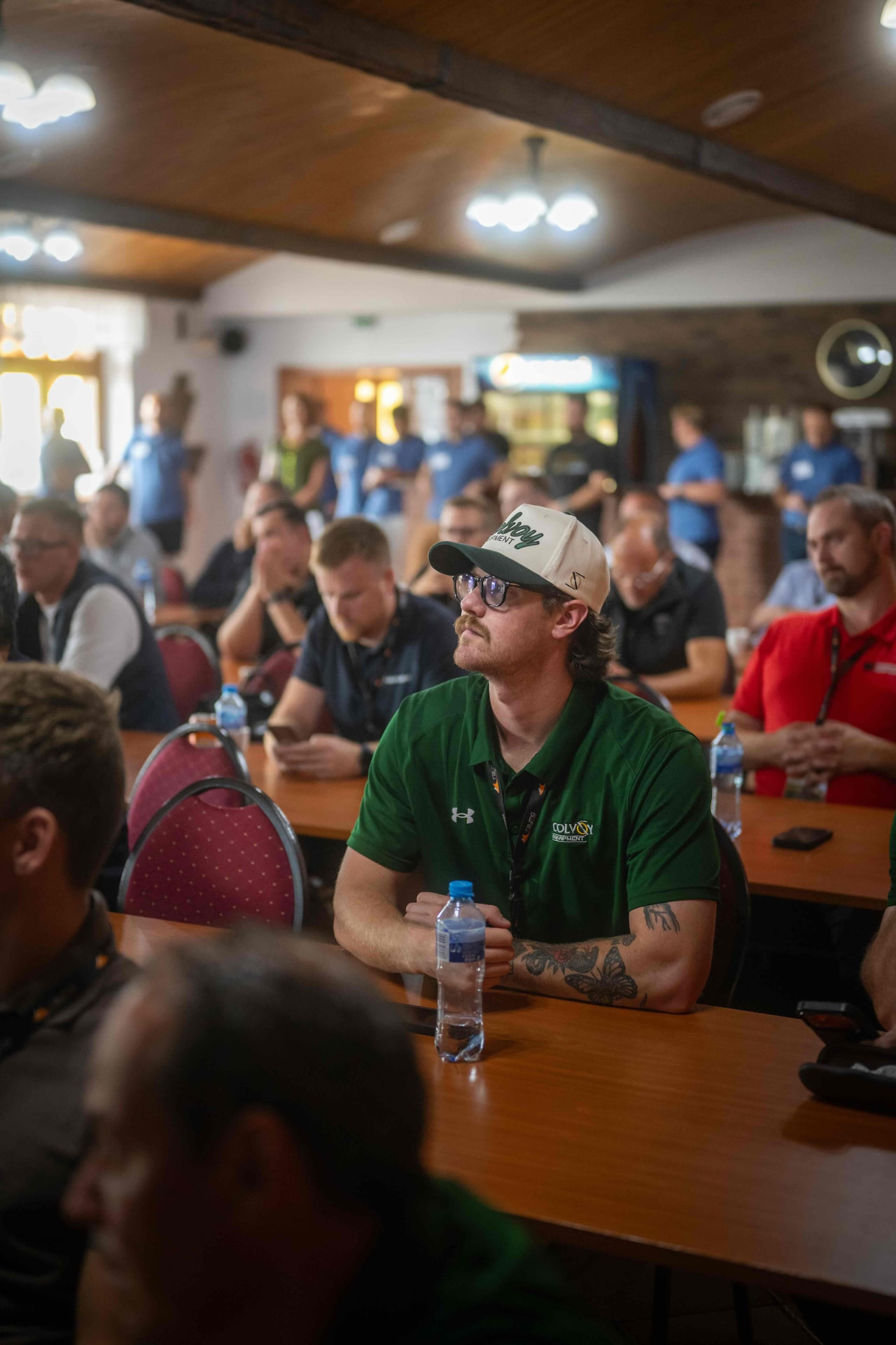 Distributor in a green polo shirt following the presentation