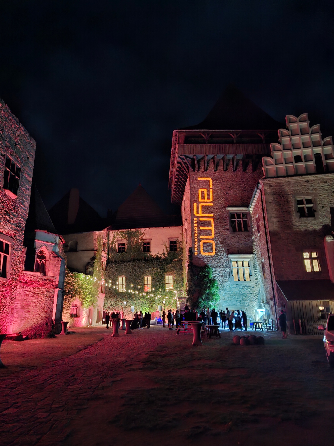 Castle Lipnice illuminated at night with the Raymo logo