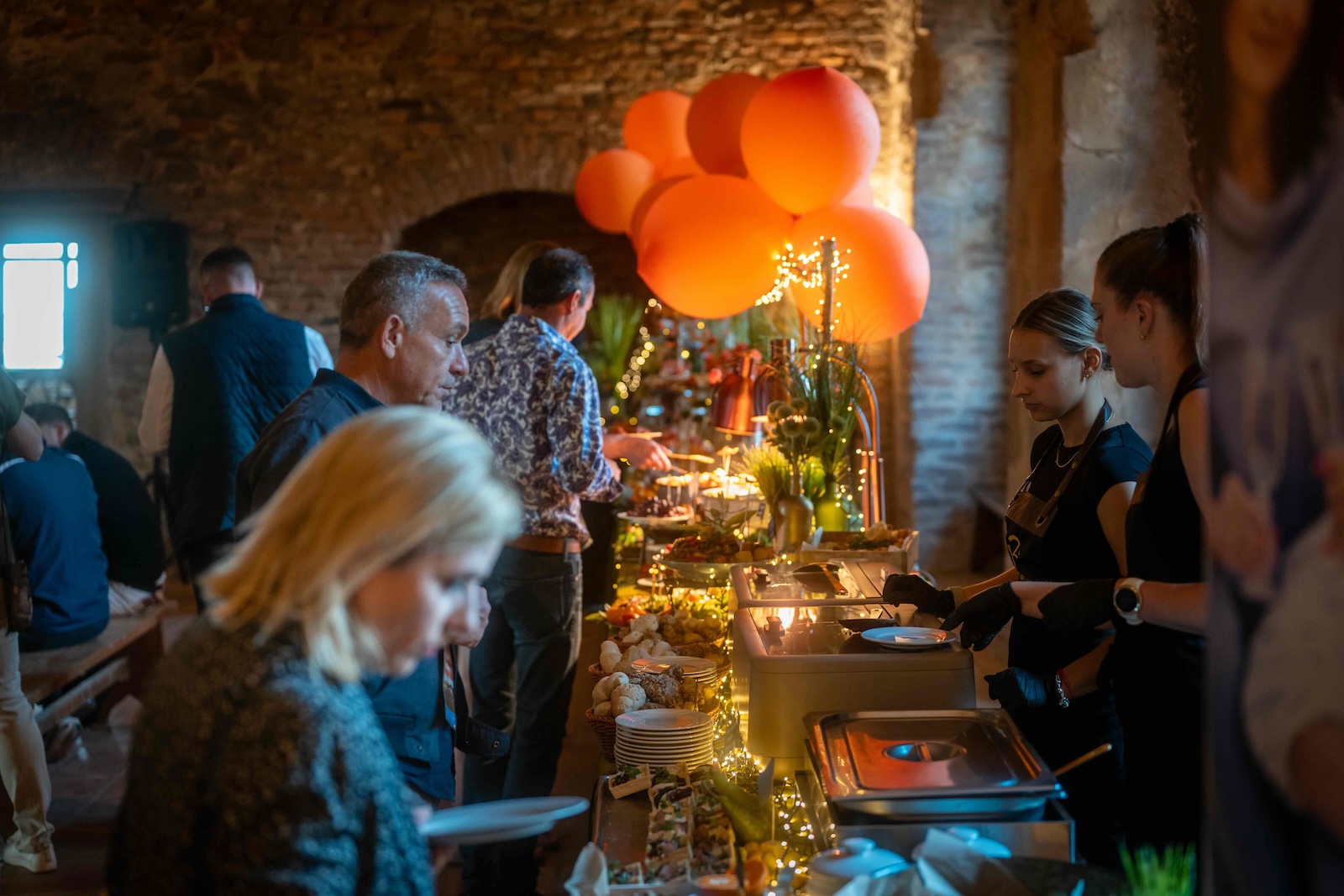 Guests served at the buffet line during the castle evening