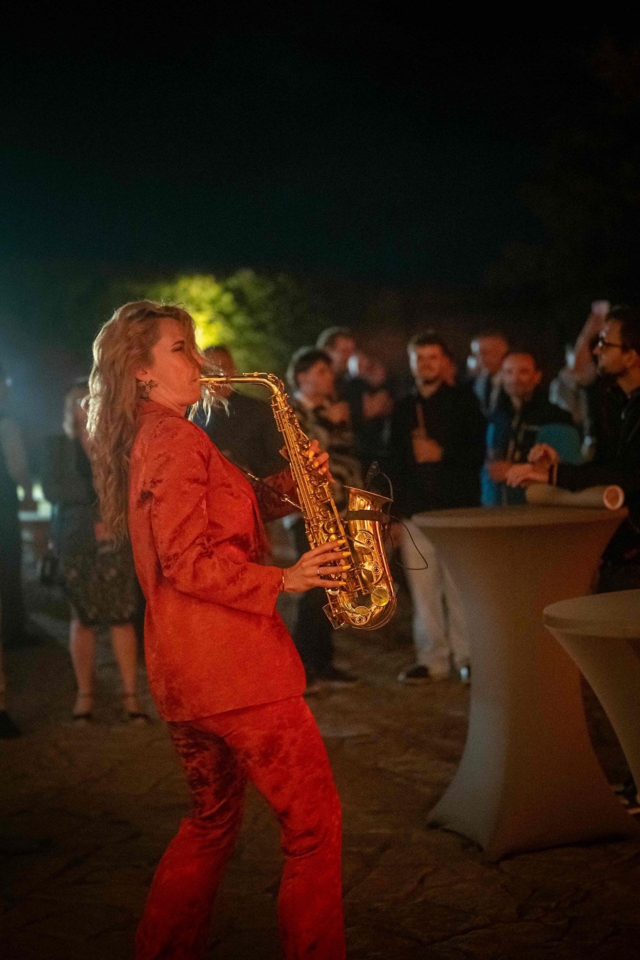 Saxophonist playing among the guests at the gala night