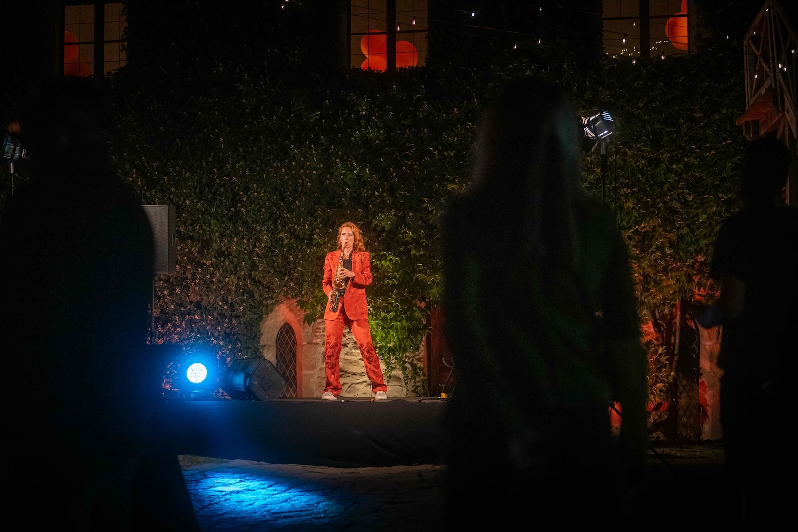 Audience watching the saxophone performance in the castle courtyard
