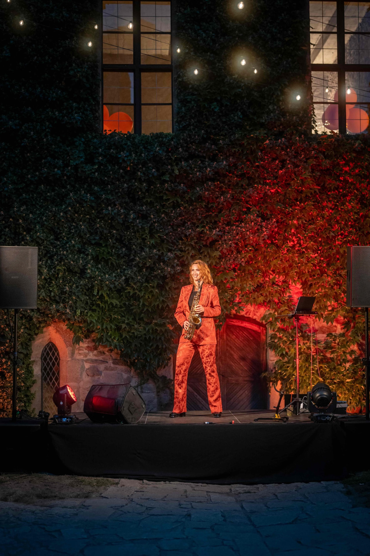Smiling saxophonist on the illuminated castle stage