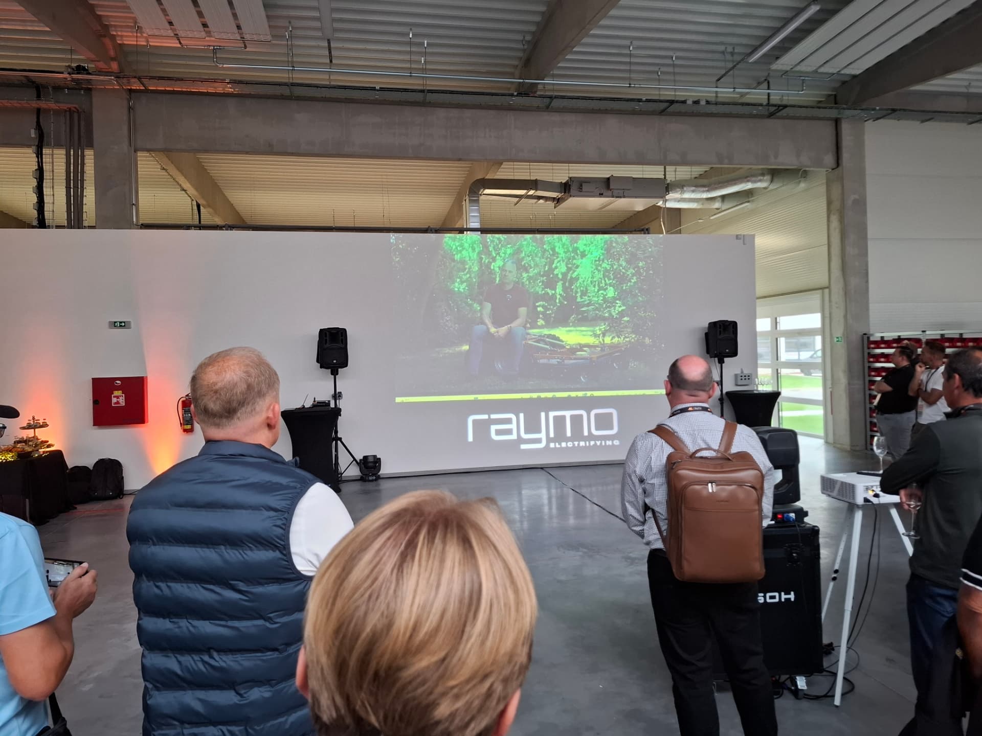 Attendees watching the Raymo story video