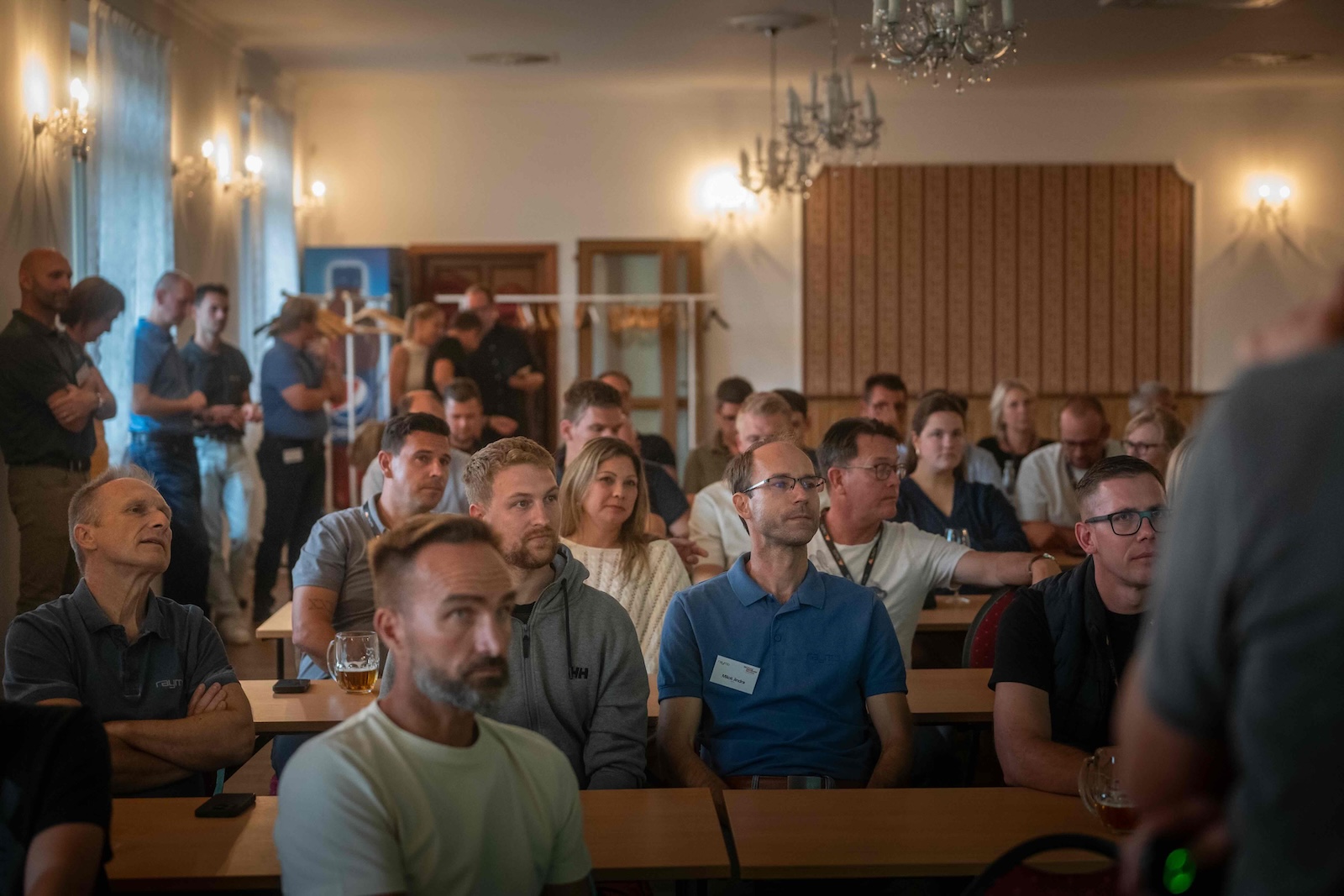 Distributors seated in the hotel conference room watching a presentation