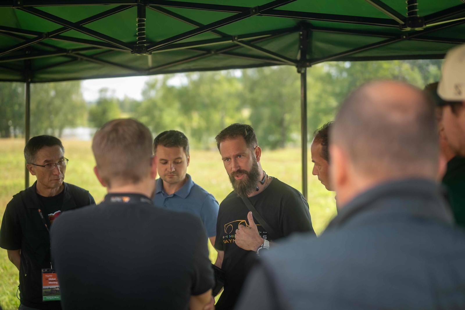 Raymo specialist explaining the machine to a group under the tent