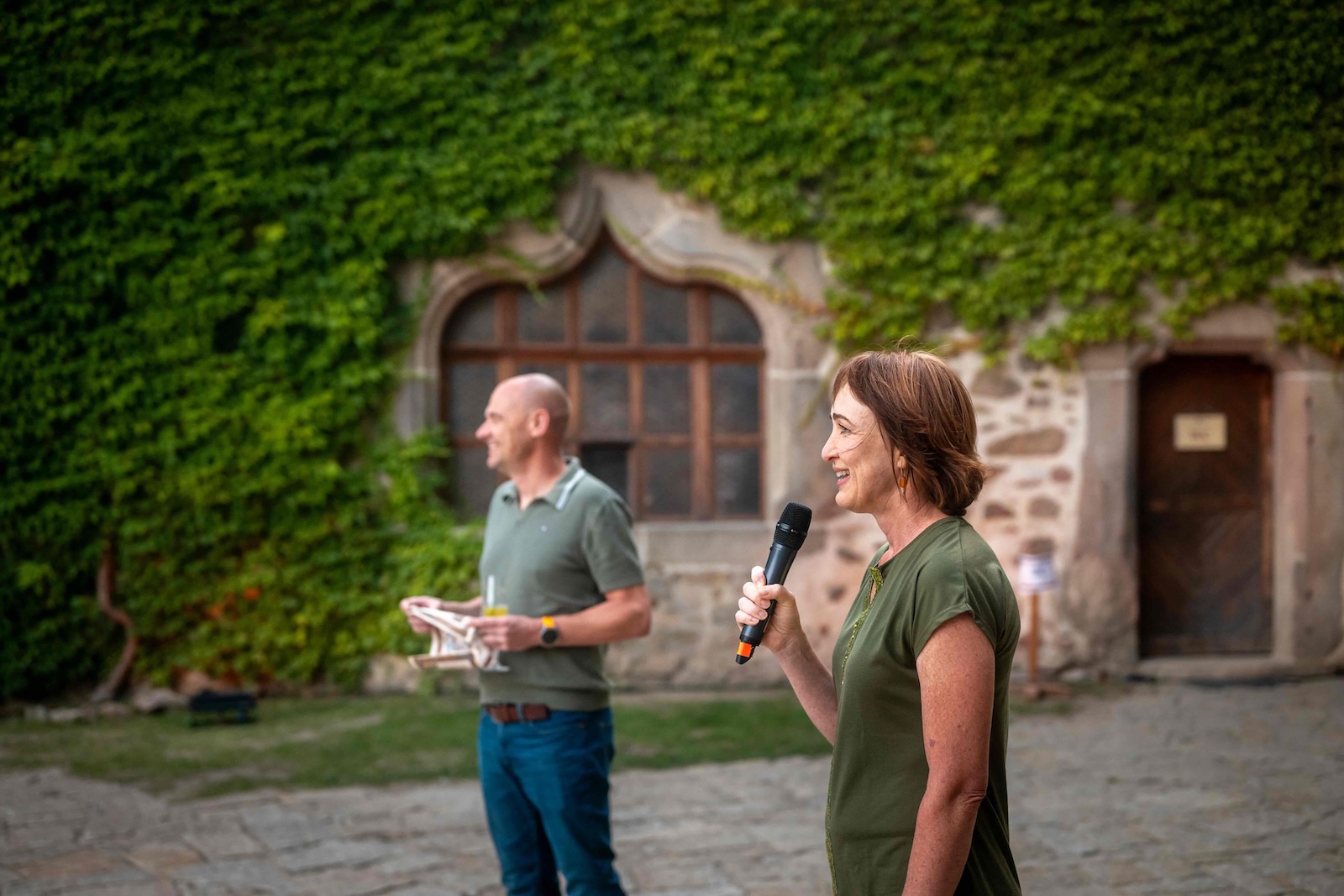 Moderator speaking into a microphone during the castle evening programme