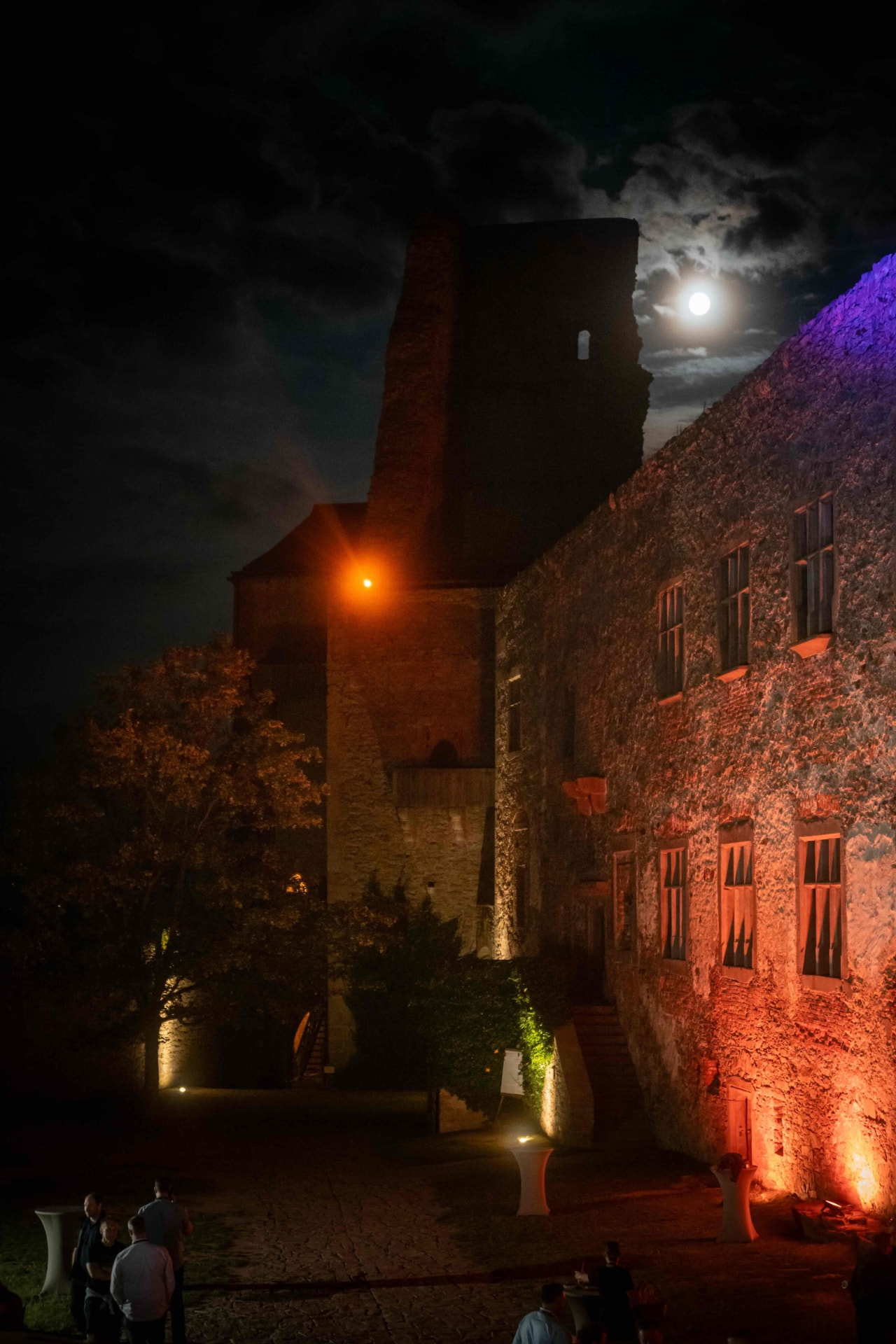 Castle Lipnice at night under a full moon with red lighting