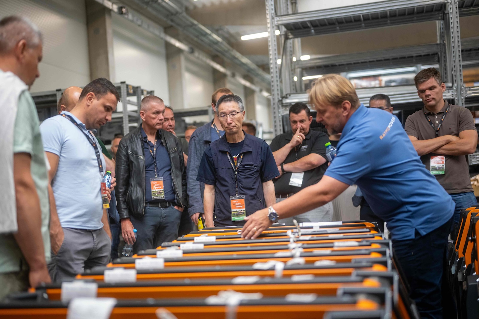 Raymo specialist explaining mowing decks to a group of distributors