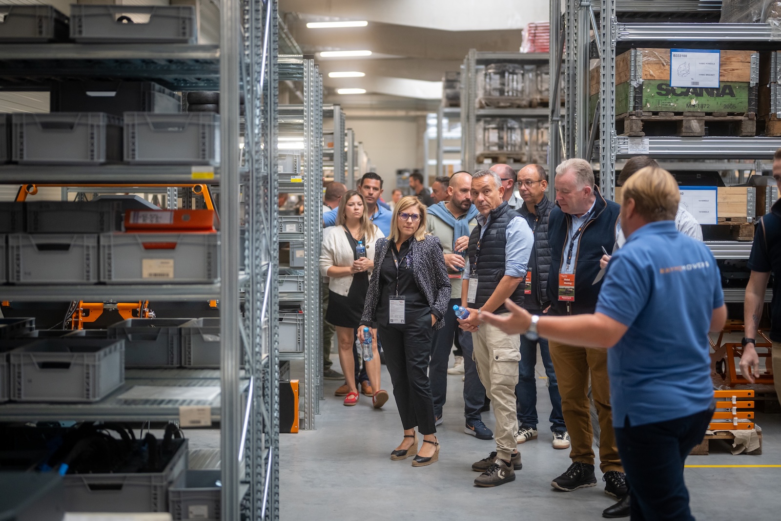 Guests walking through the parts warehouse during the guided tour