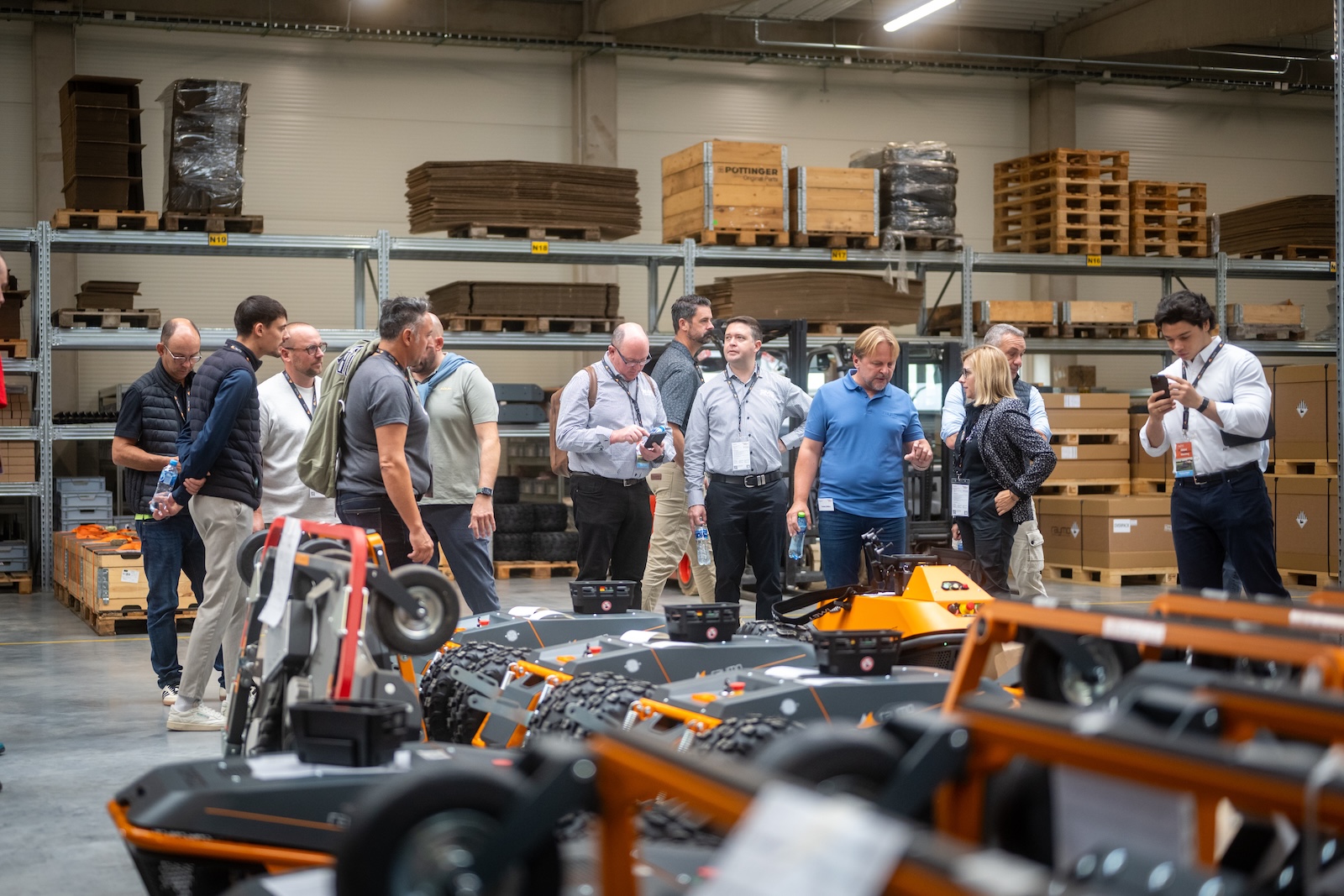 Distributors inspecting a row of new Raymo machines in the warehouse