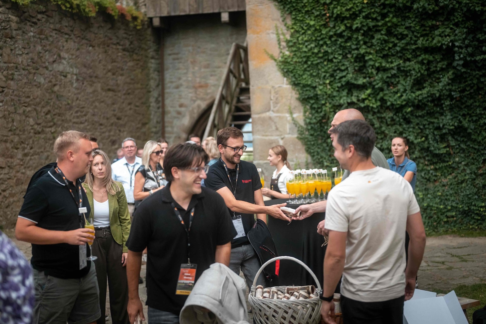 Guests receiving welcome drinks in the castle courtyard