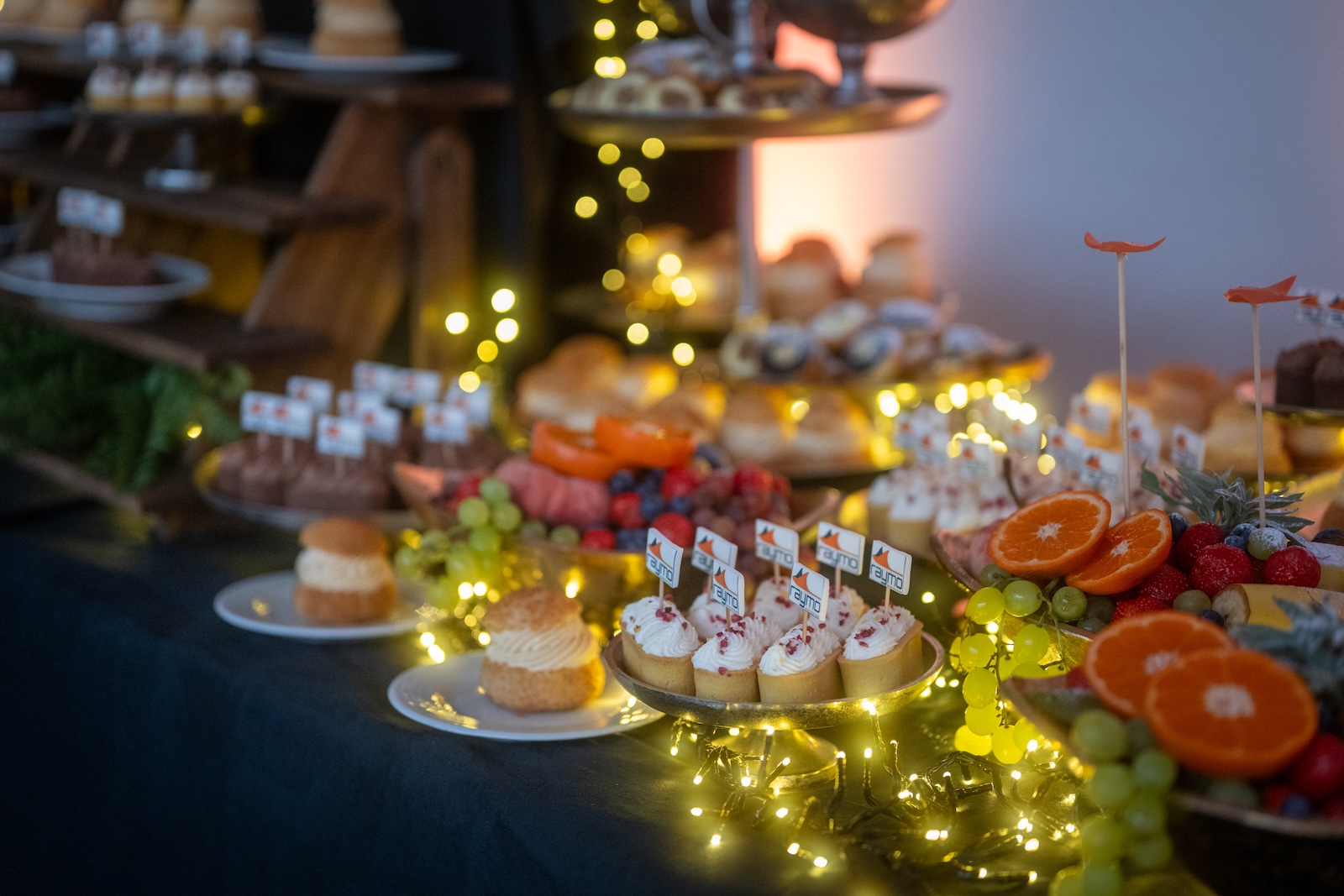 Close-up of Raymo branded desserts on the buffet table
