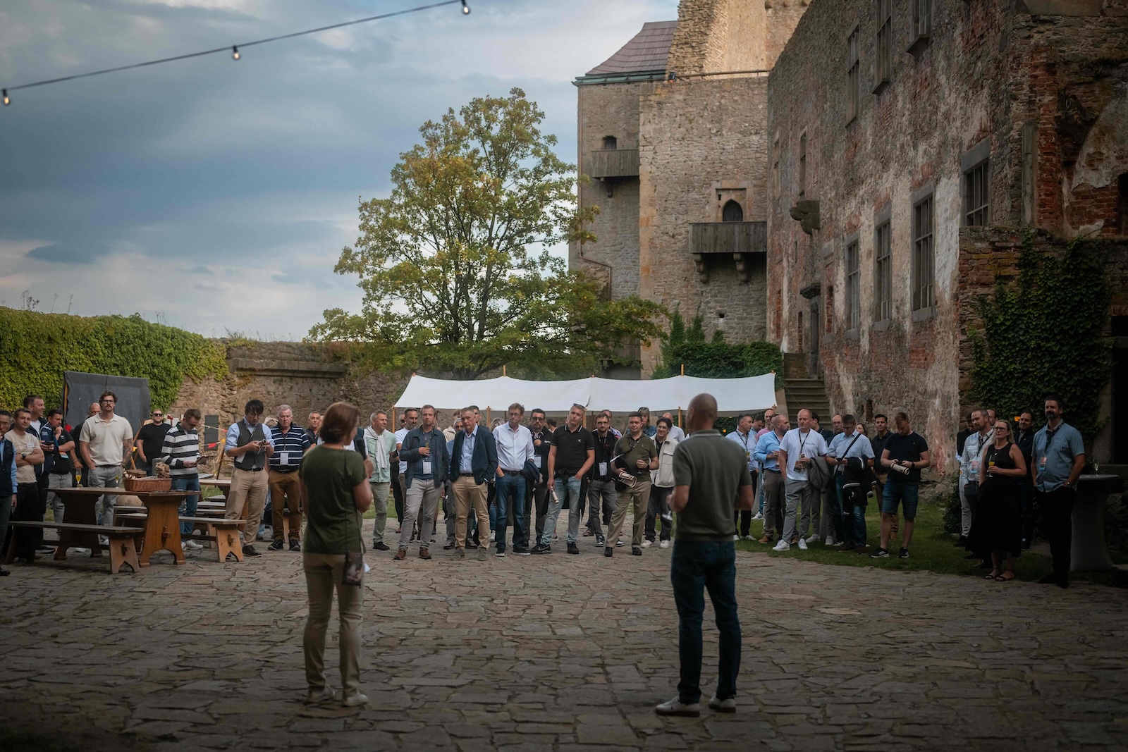 Wide view of the audience listening to the speech in the castle courtyard