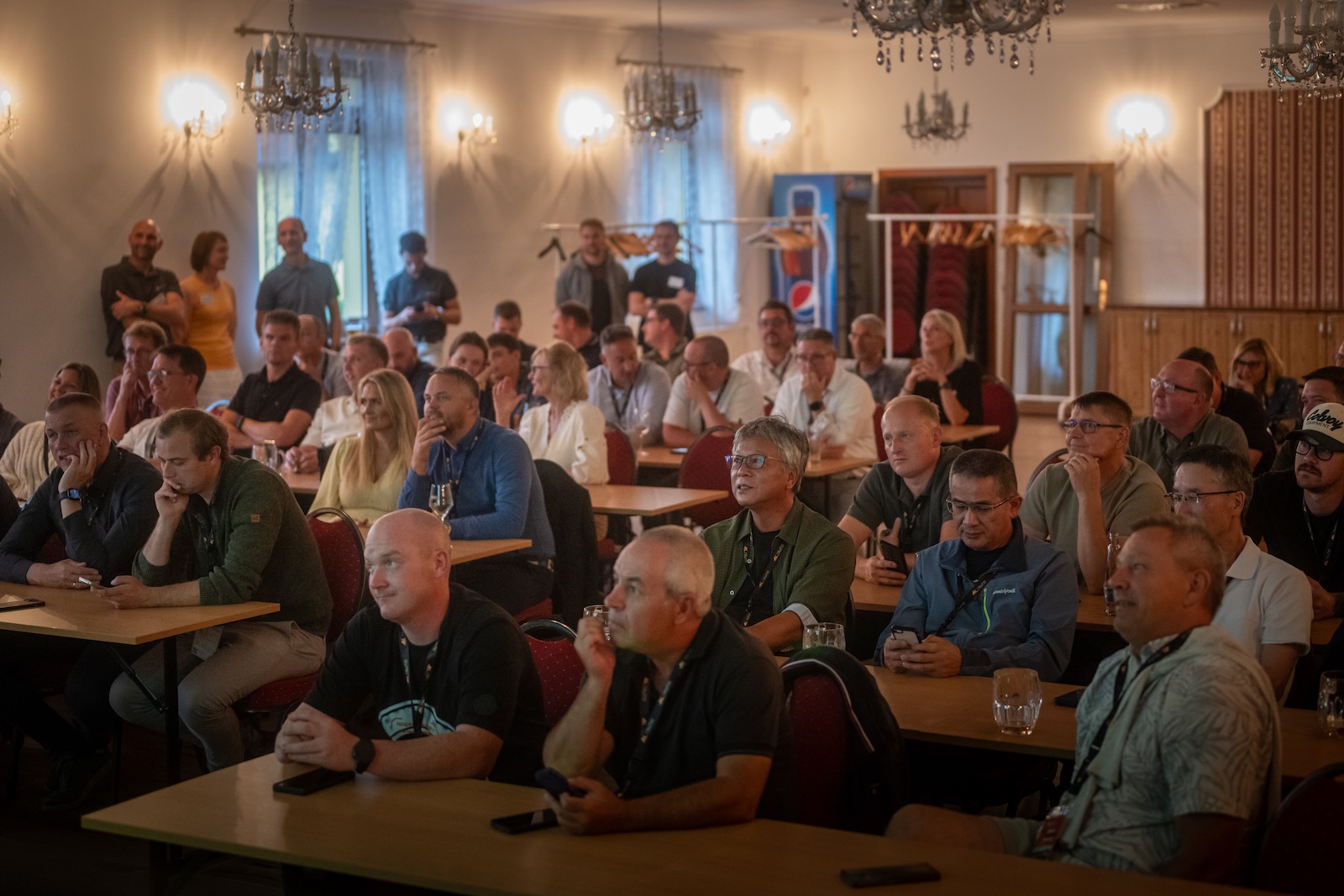 Full conference room of distributors listening to a presentation