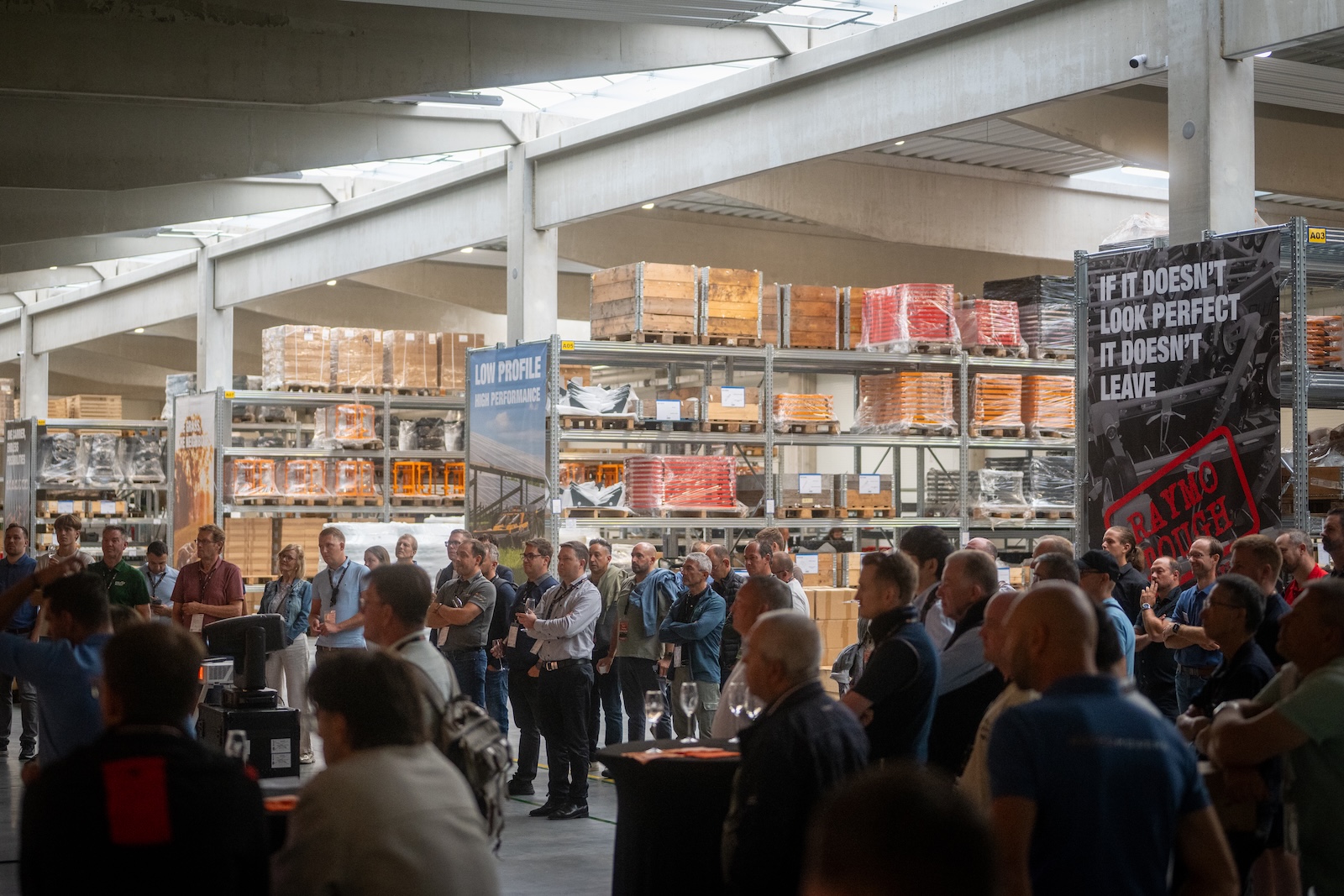 Large crowd of distributors listening in the new production hall
