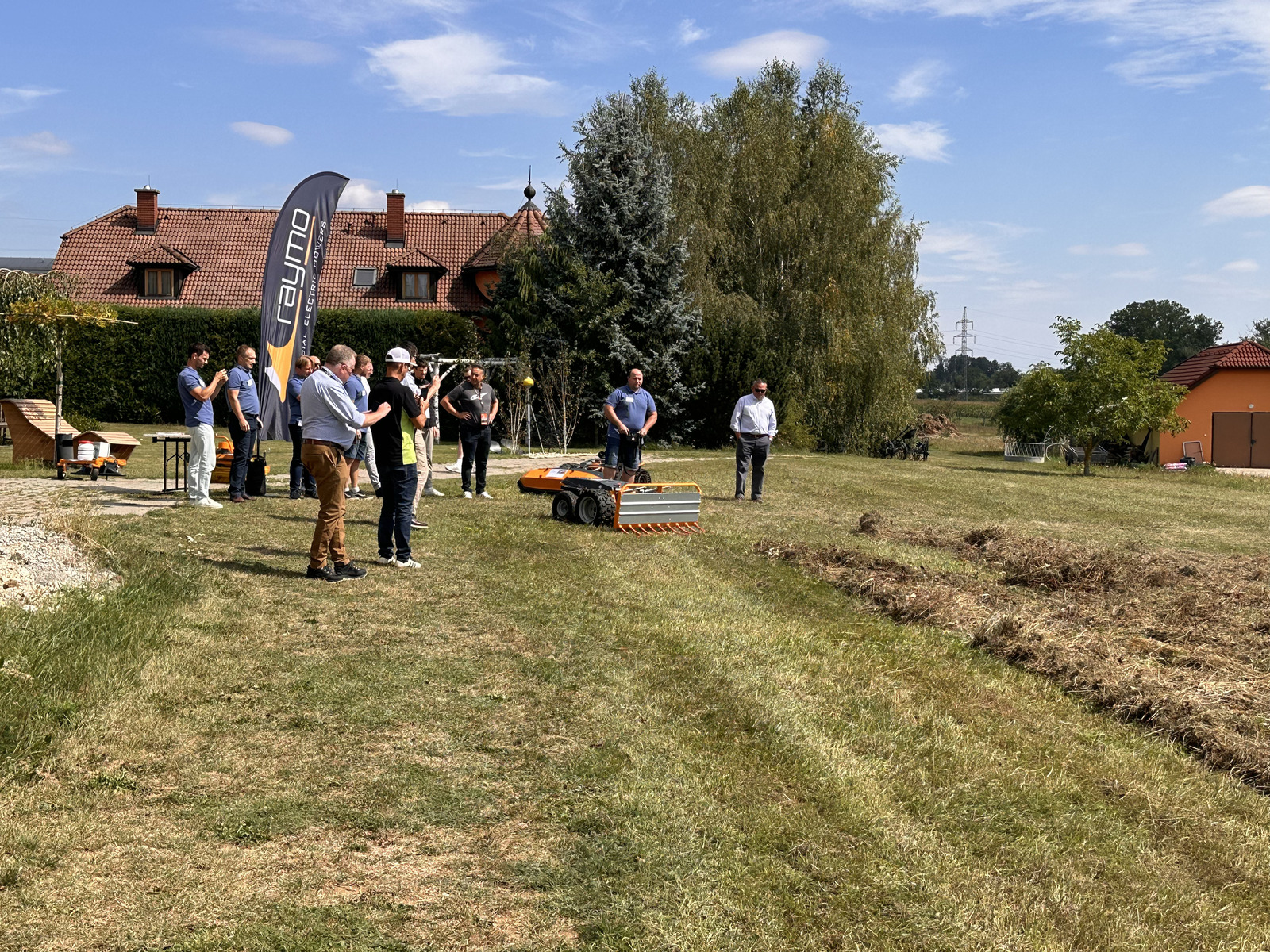 Raymo Torpedo robot working on the meadow in front of the hotel