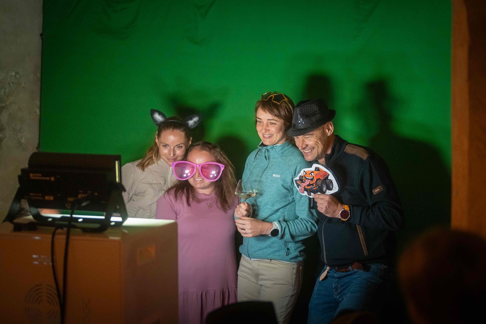 Group of guests with props in front of the green screen