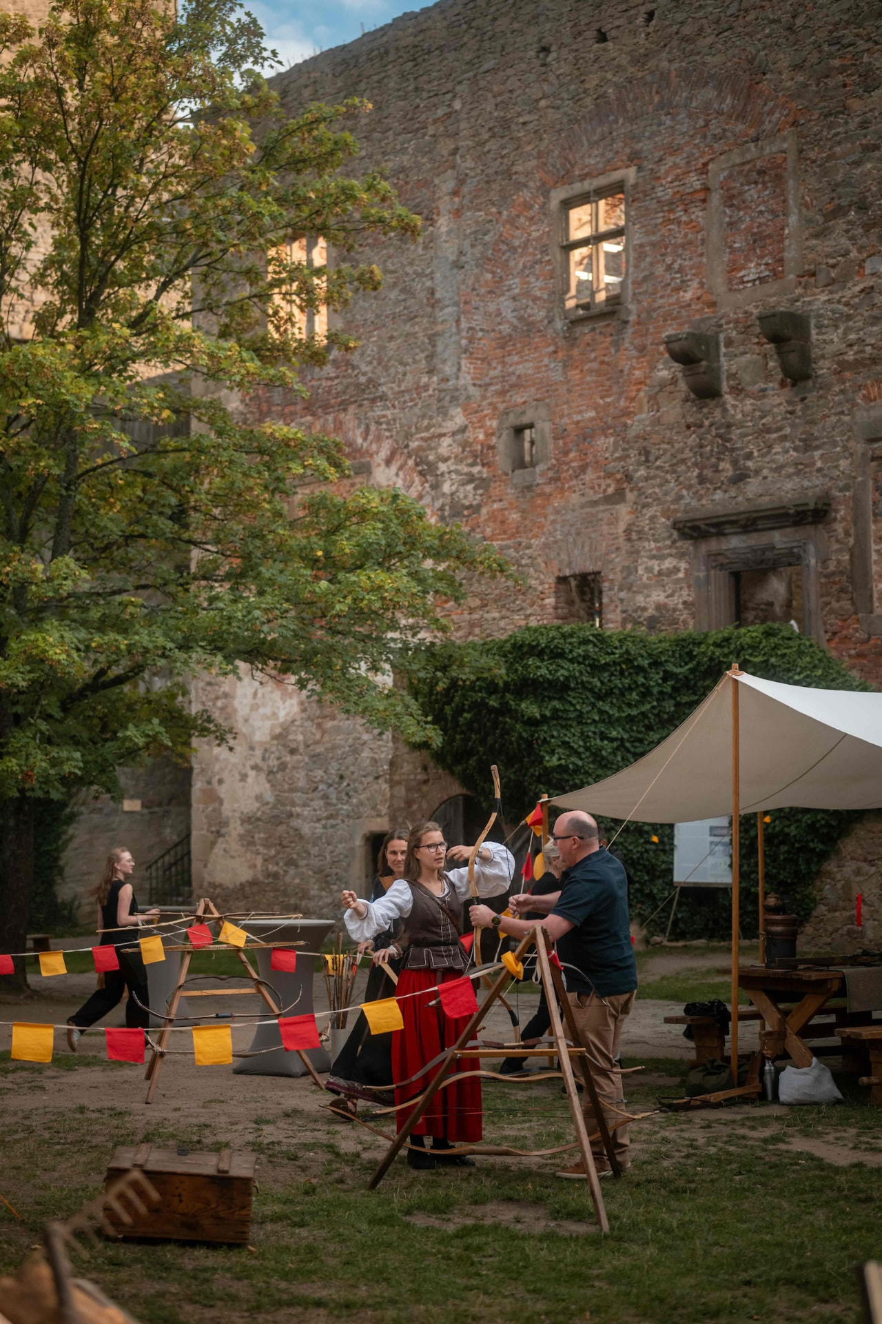 Archery station with flags and bows in the castle courtyard