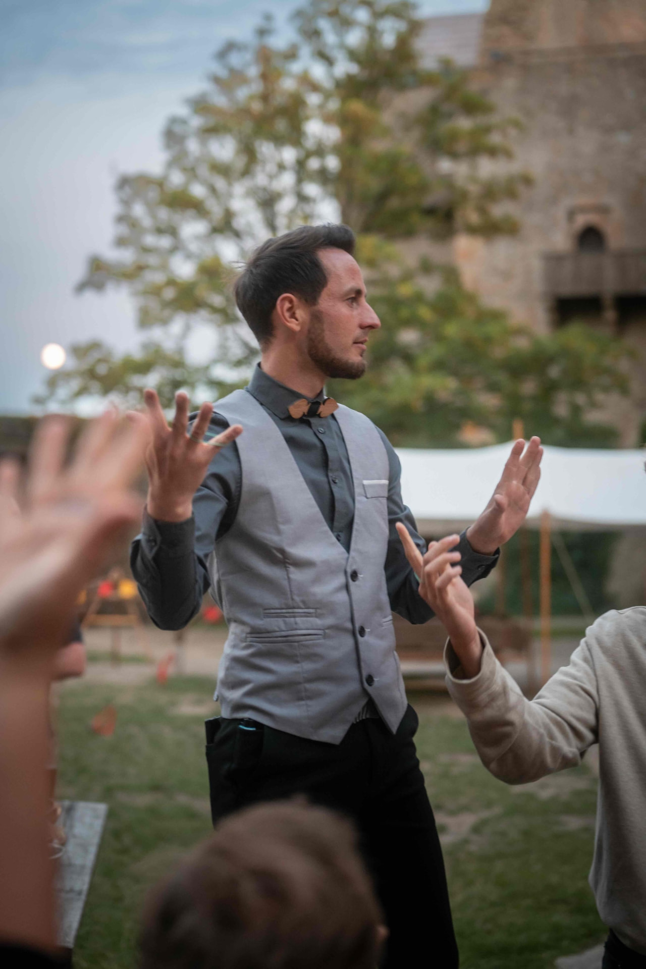 Entertainer leading an interactive game with the guests in the courtyard