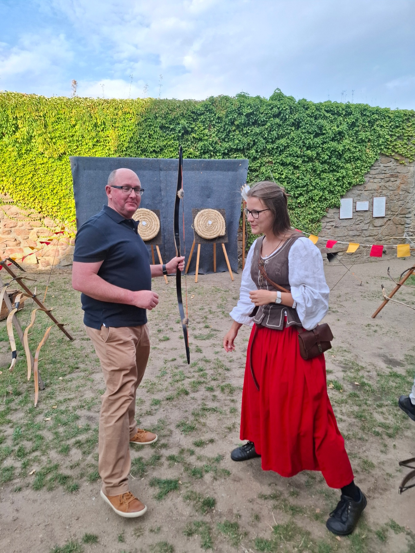 Guest with a bow next to an archer in historical costume