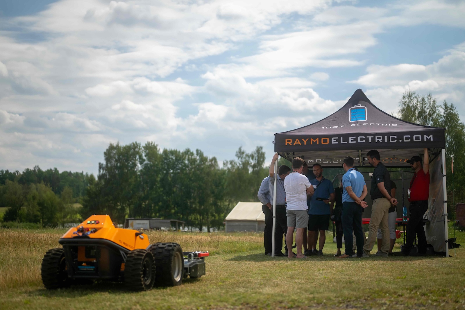 Orange Raymo carrier on the field next to the RaymoElectric.com tent