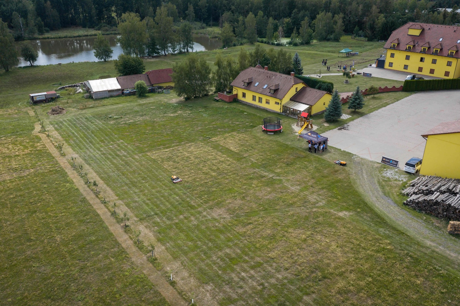 Aerial view of the demo meadow, pond and Hotel Tri Vezicky