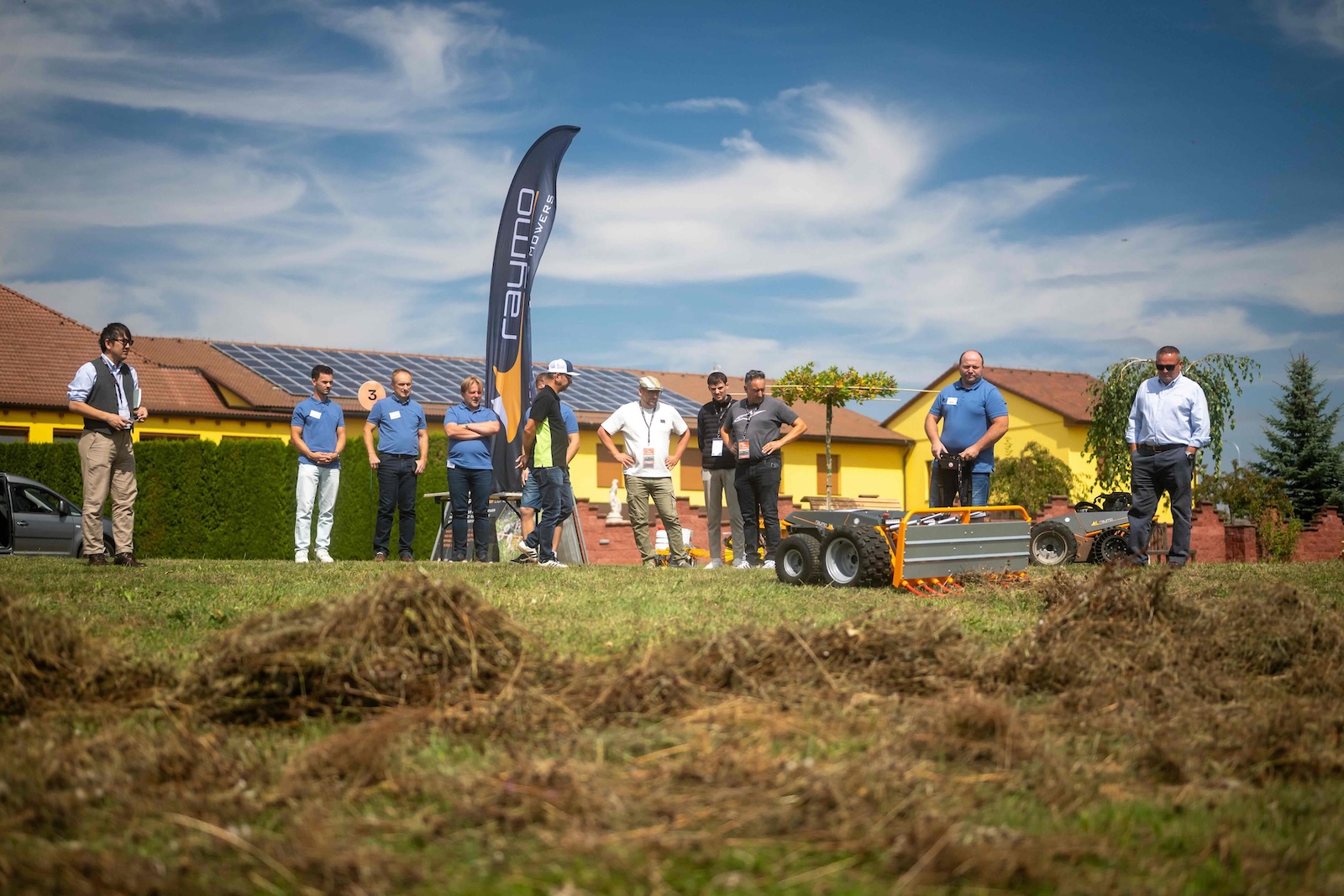 Attendees watching a Raymo carrier with an attachment on the demo field