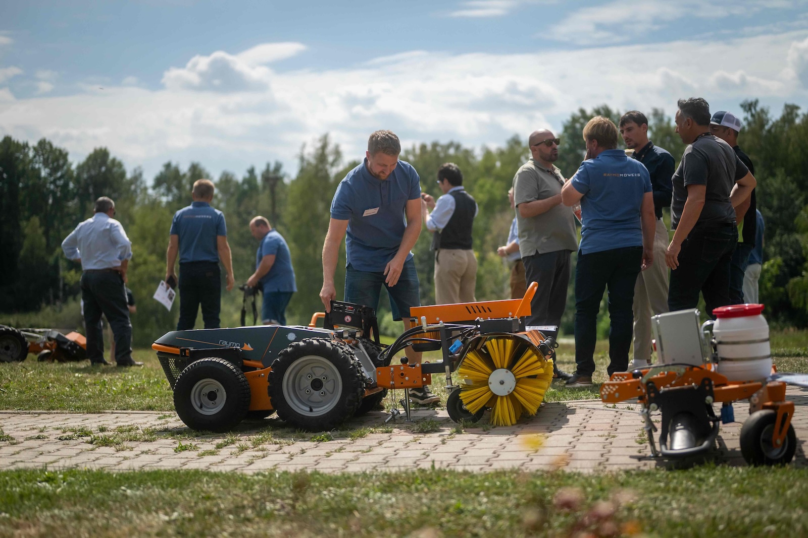 Raymo carrier with a sweeper brush attachment shown to distributors