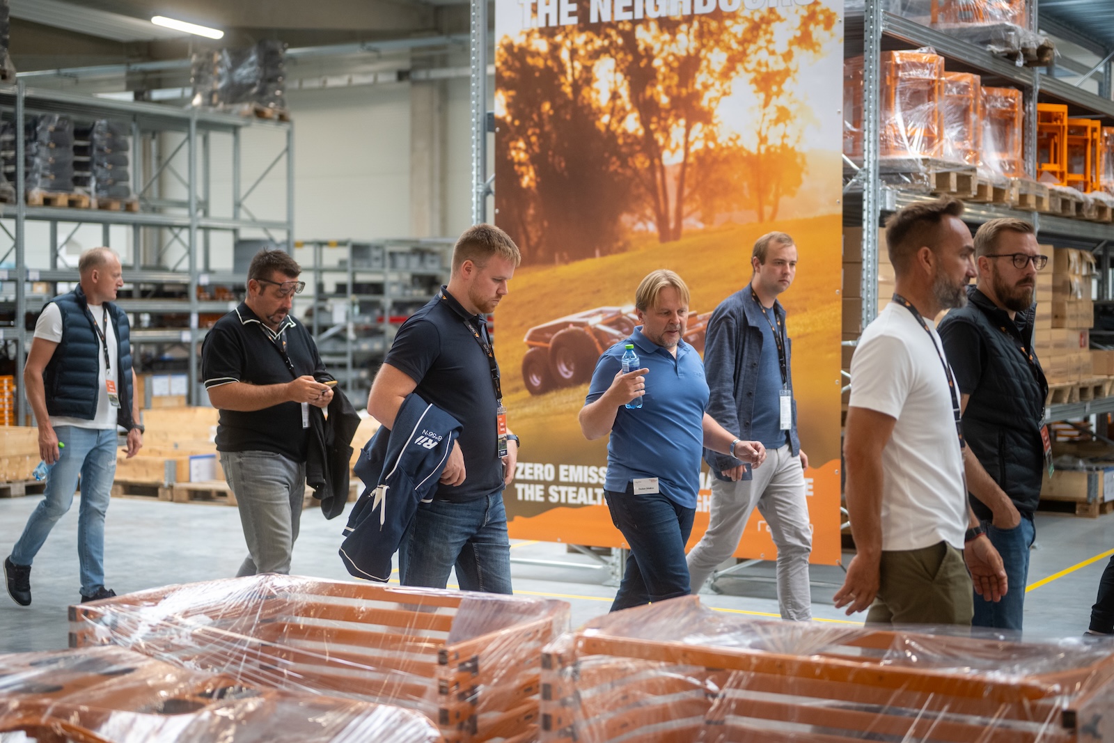 Distributors walking past the Zero Emissions banner in the warehouse