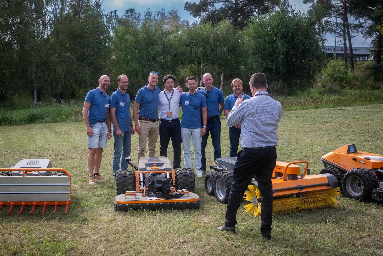 Raymo team posing behind the line-up of machines and attachments