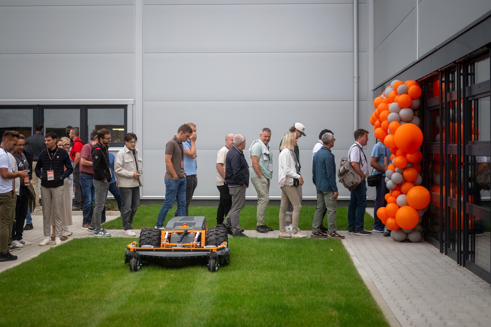 Distributors watching a mower demonstration on the lawn