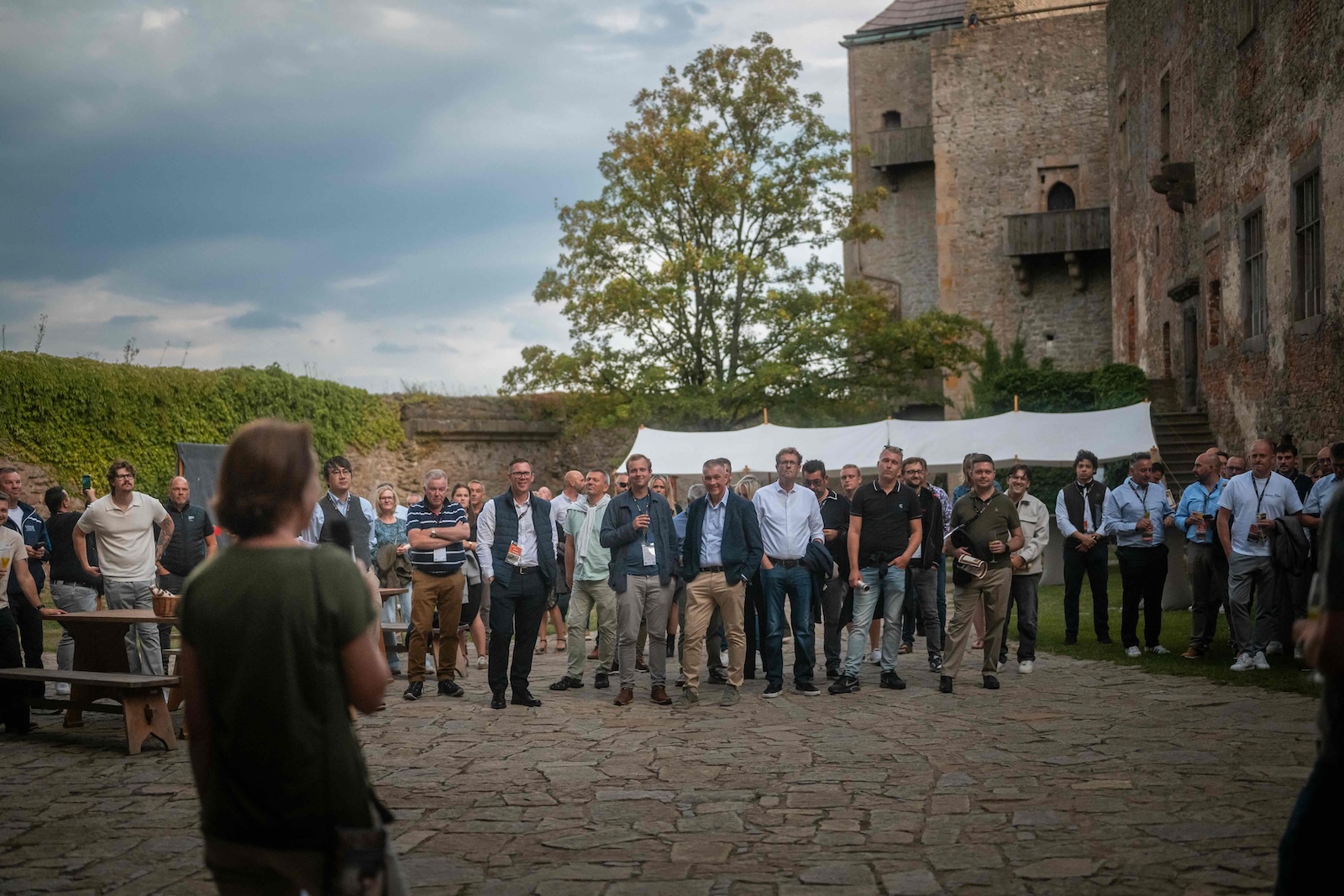 Crowd listening to the opening speech in the castle courtyard
