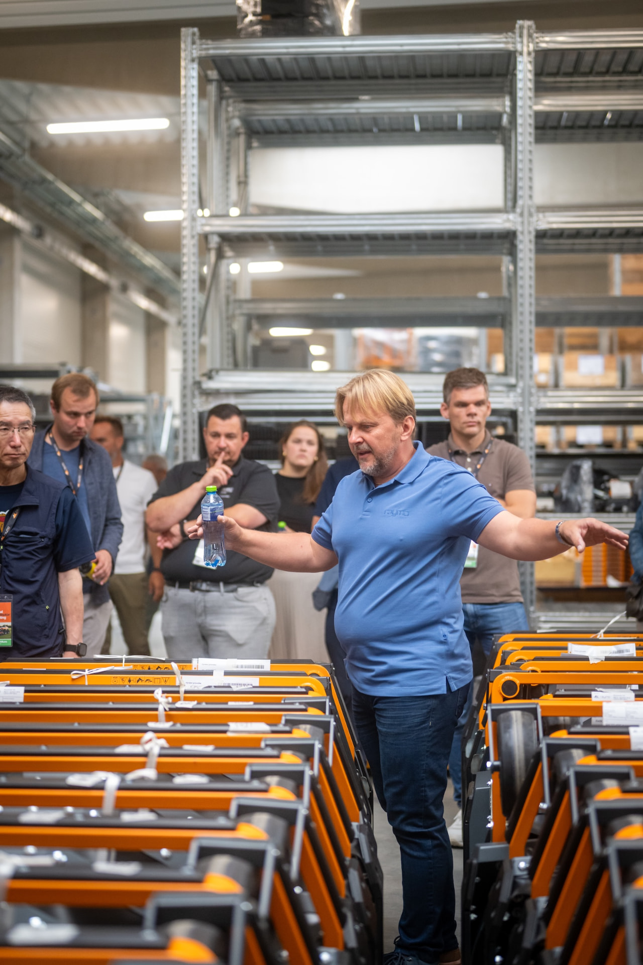 Raymo host explaining the production flow between rows of machines