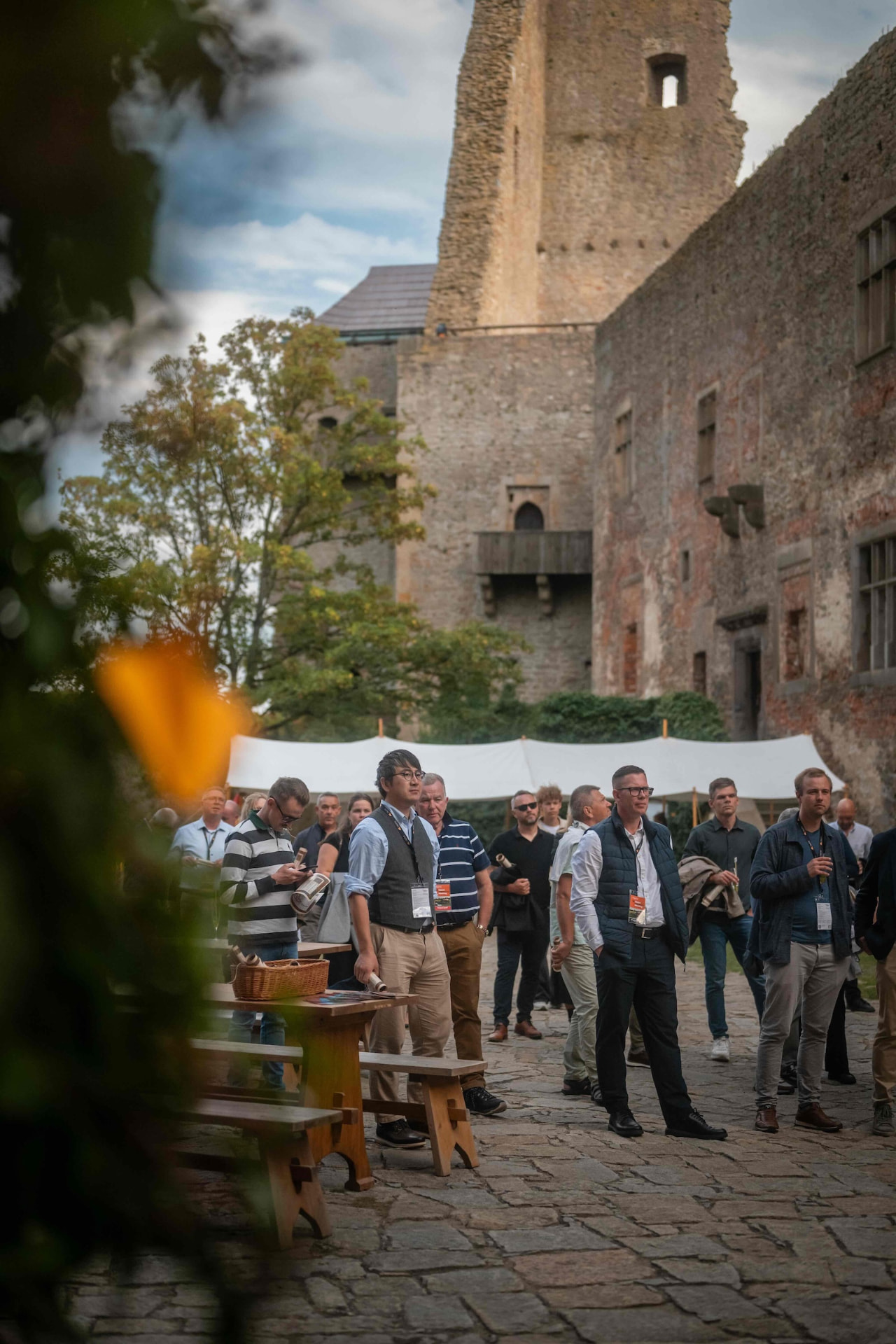 Guests standing in the castle courtyard with the tower in the background